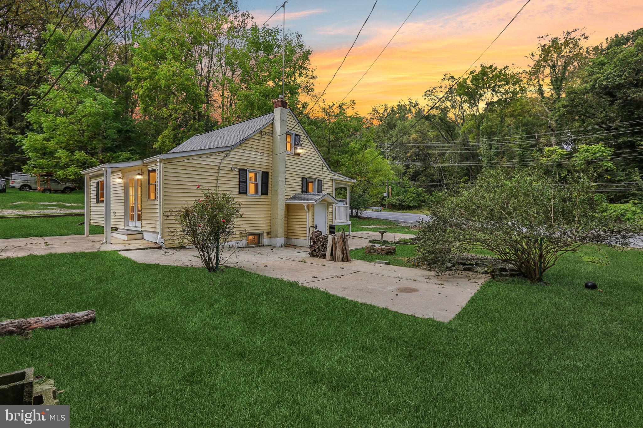 a view of a backyard with table and chairs and potted plants