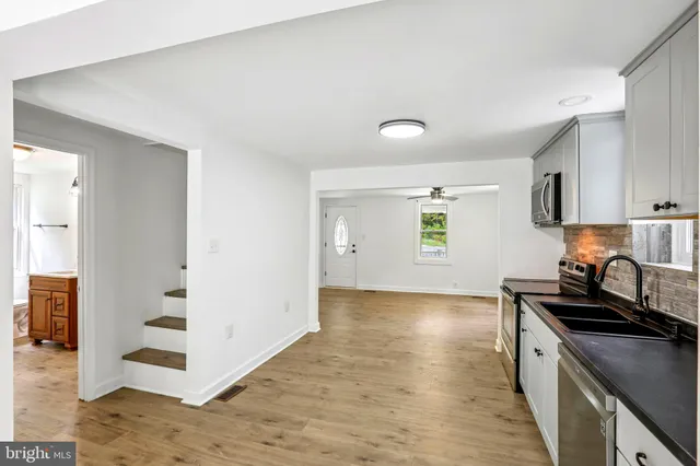 a kitchen with granite countertop a stove and a sink