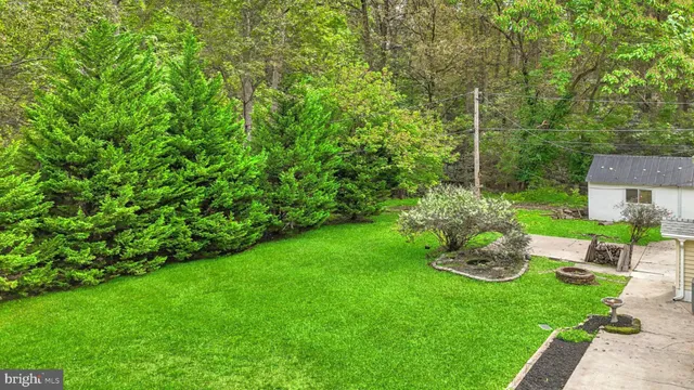a view of a house with backyard sitting area and garden
