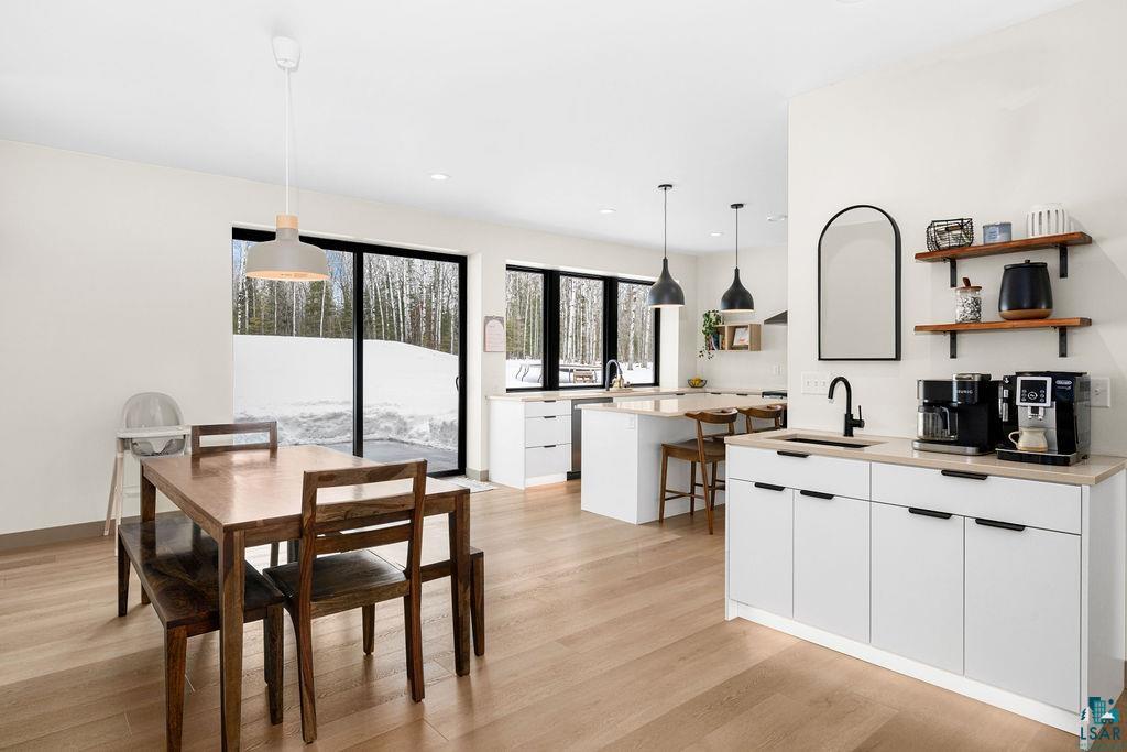 1491 Wildwood Road Duluth, MN 55804 - Photo 14 of 38 Dining space featuring light wood-style floors and baseboards