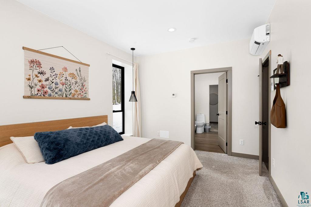 1491 Wildwood Road Duluth, MN 55804 - Photo 19 of 38 Carpeted bedroom featuring a mini split for heating / cooling and ensuite full bath w/soaking tub.