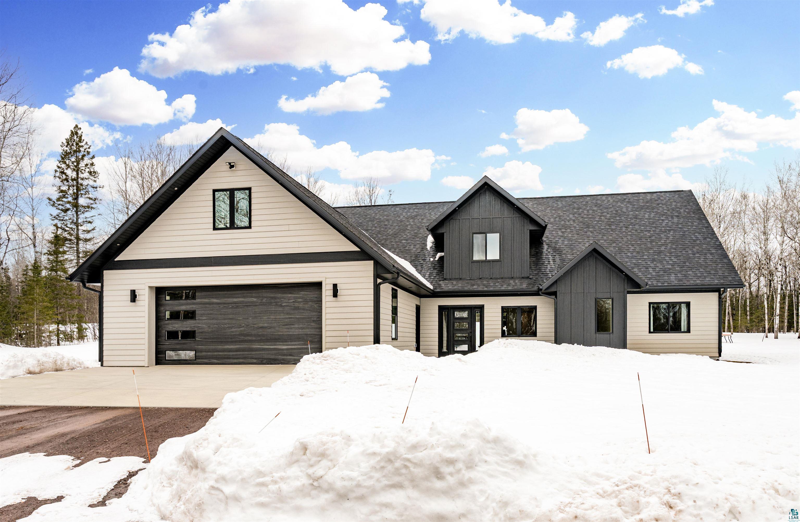1491 Wildwood Road Duluth, MN 55804 - Photo 2 of 38 Modern inspired farmhouse with board and batten siding, driveway, a shingled roof, and a garage
