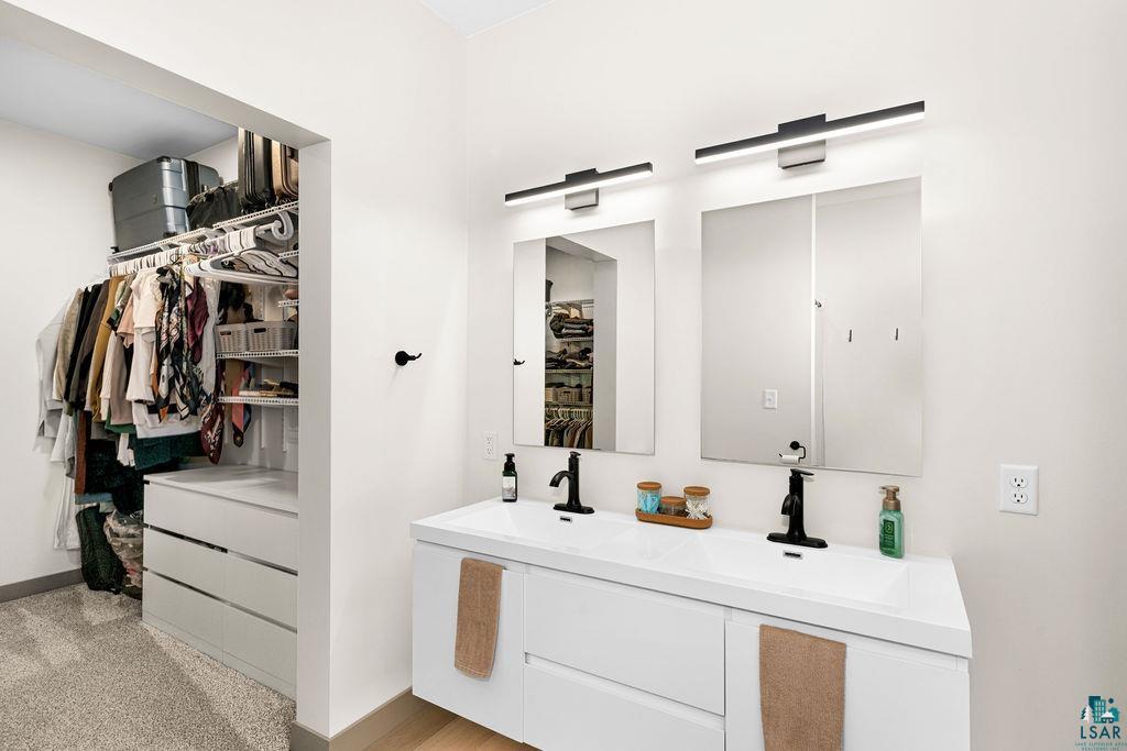 1491 Wildwood Road Duluth, MN 55804 - Photo 23 of 38 Full bathroom featuring double vanity and a walk in closet.