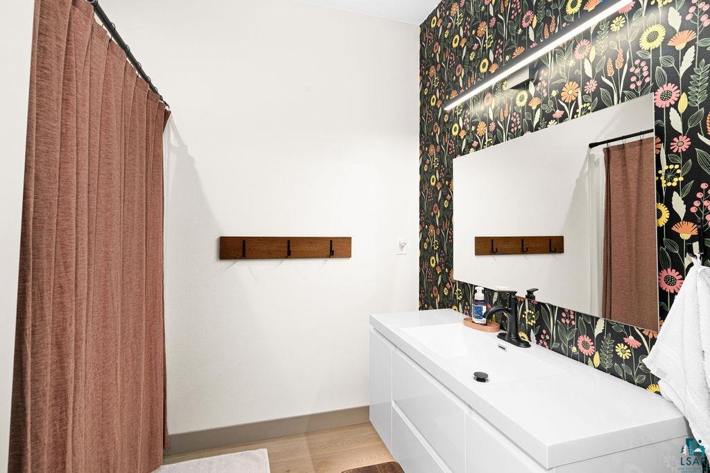 1491 Wildwood Road Duluth, MN 55804 - Photo 27 of 38 Full bathroom featuring vanity and light wood-type flooring.