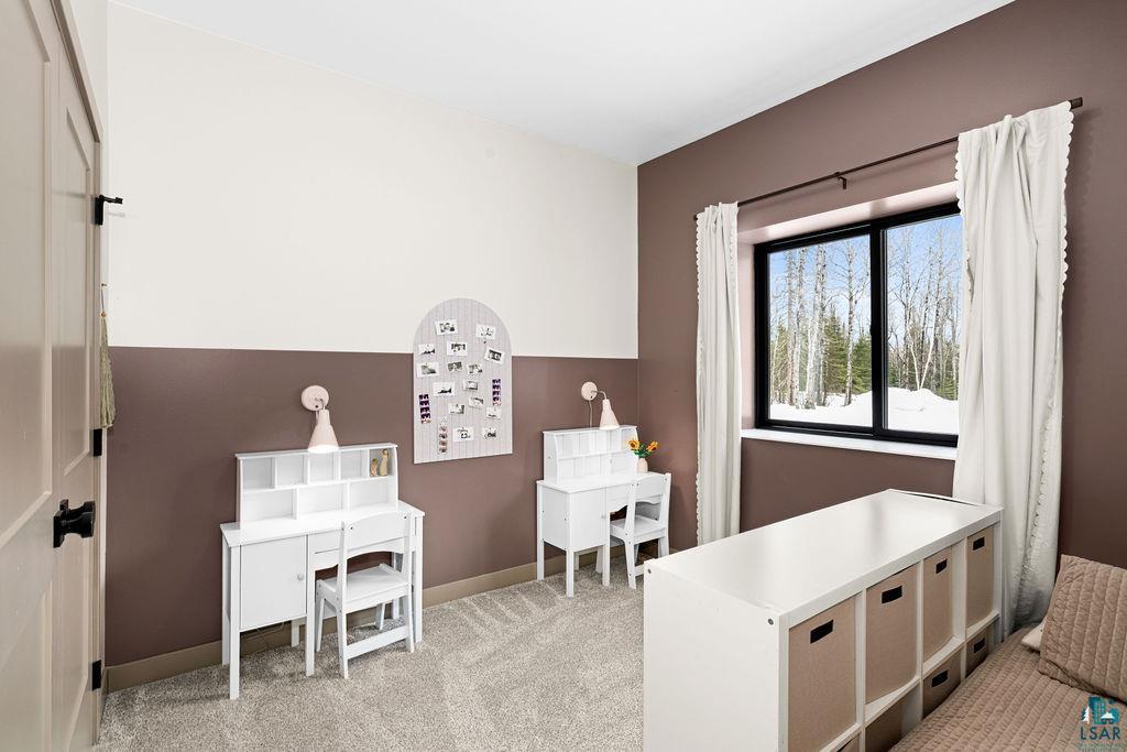 1491 Wildwood Road Duluth, MN 55804 - Photo 28 of 38 9 foot tall ceilings in bedroom or den/office area with light carpet and baseboards.