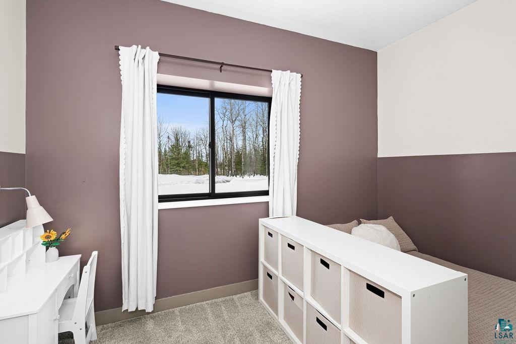 1491 Wildwood Road Duluth, MN 55804 - Photo 29 of 38 Bedroom with light colored carpet and baseboards.