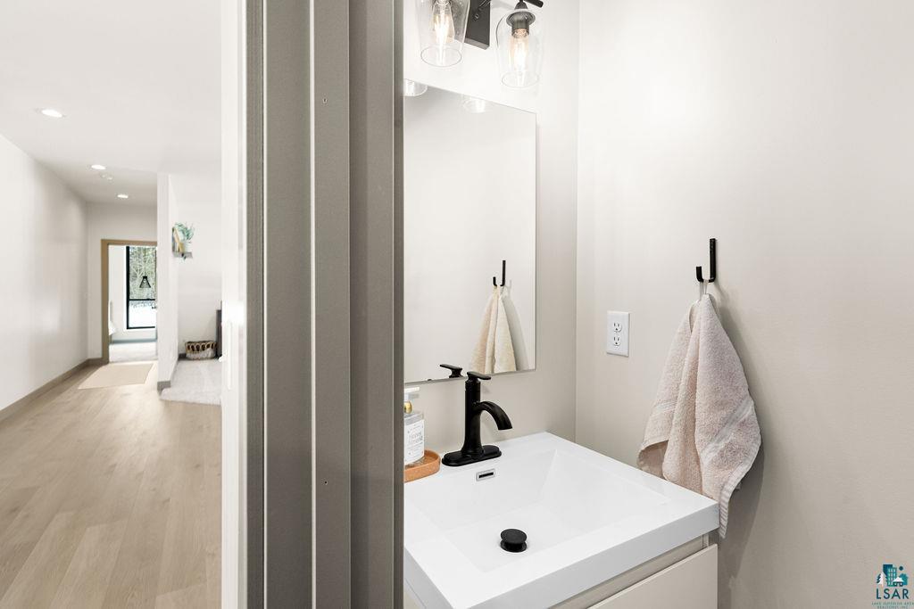 1491 Wildwood Road Duluth, MN 55804 - Photo 30 of 38 Half bathroom featuring vanity, light style flooring.