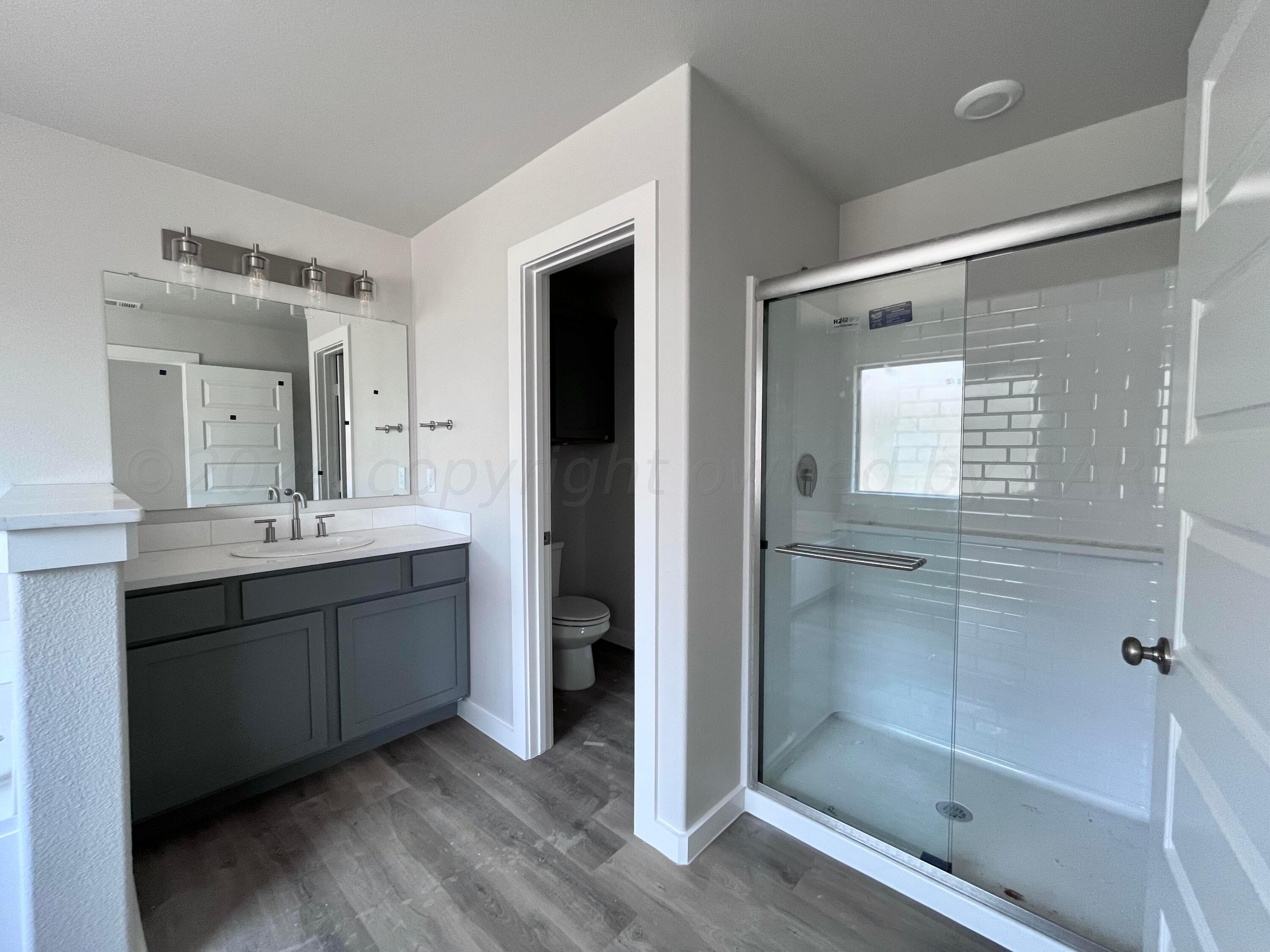 1605 Moon River Road Amarillo, TX 79118 - Photo 12 of 17 a bathroom with a double vanity sink mirror and shower