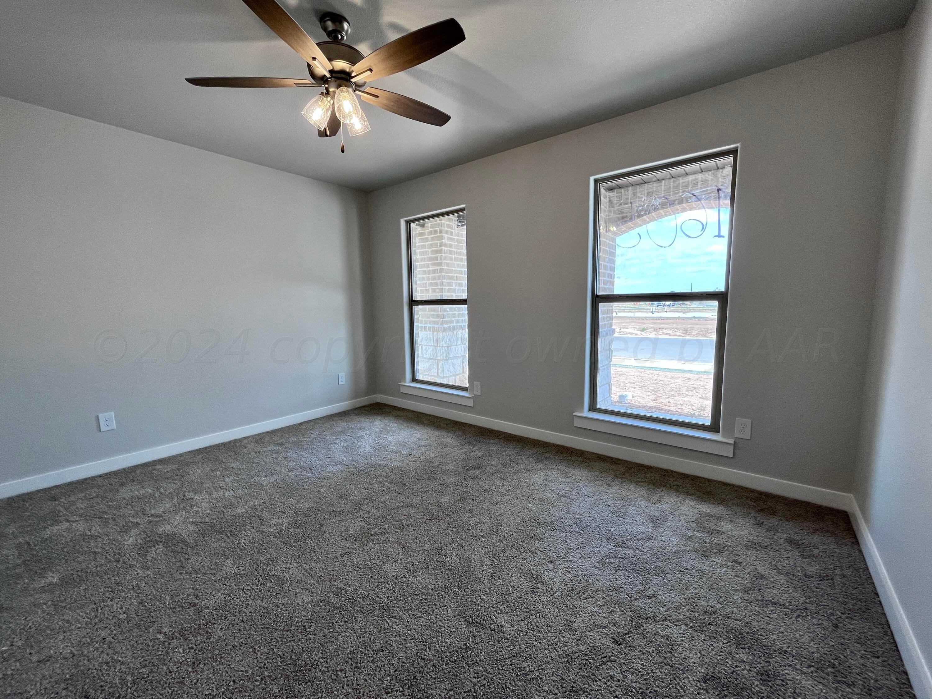 1605 Moon River Road Amarillo, TX 79118 - Photo 13 of 17 an empty room with windows and fan