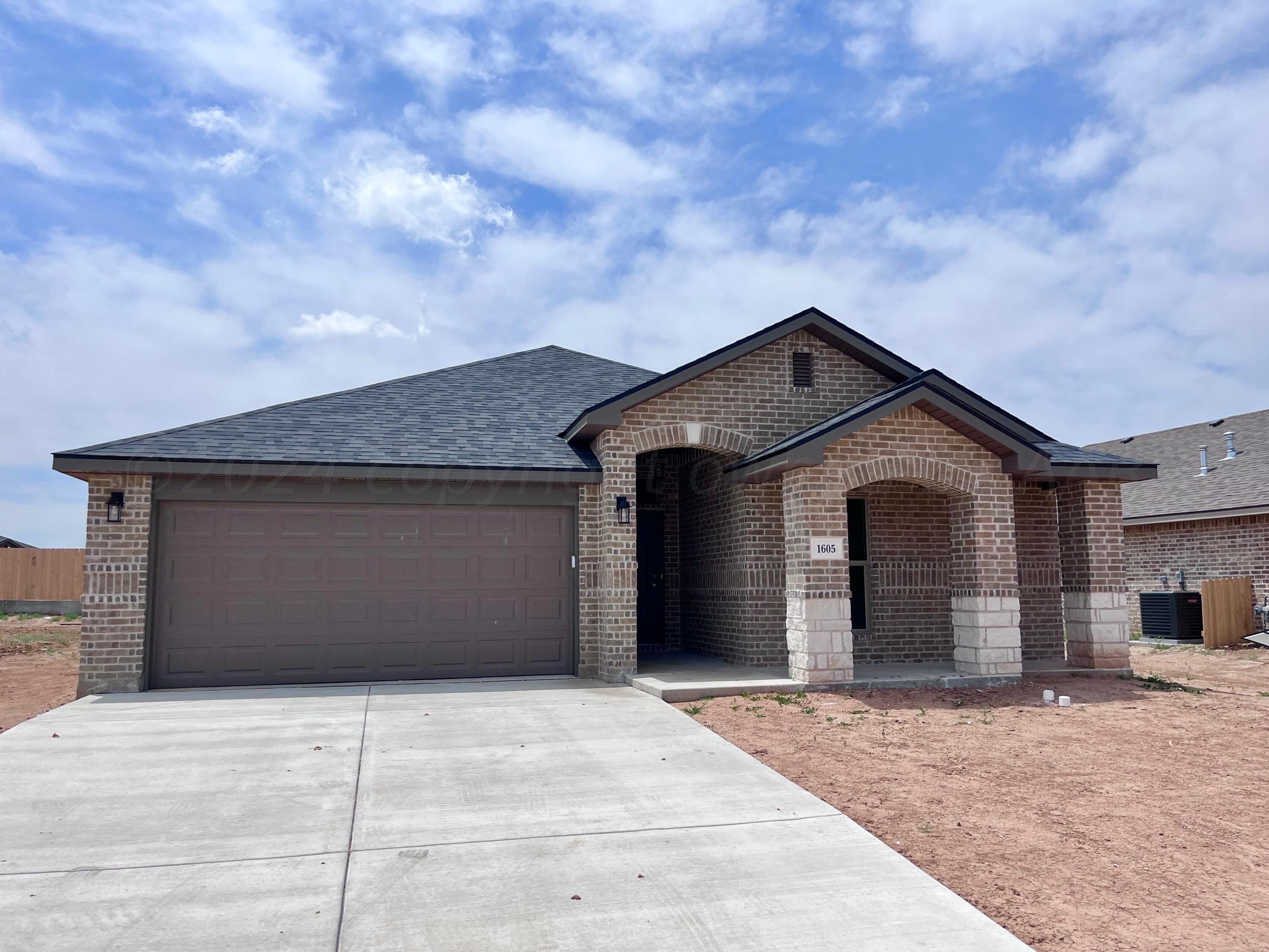 1605 Moon River Road Amarillo, TX 79118 - Photo 2 of 17 a front view of a house with a yard and garage