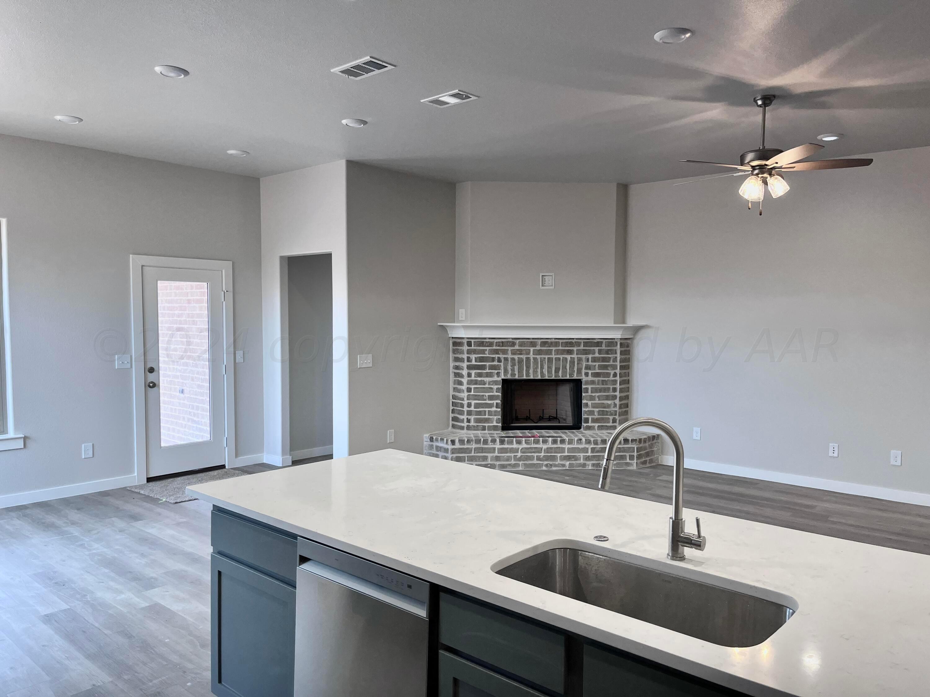 1605 Moon River Road Amarillo, TX 79118 - Photo 3 of 17 a kitchen with a sink stainless steel appliances and chandelier