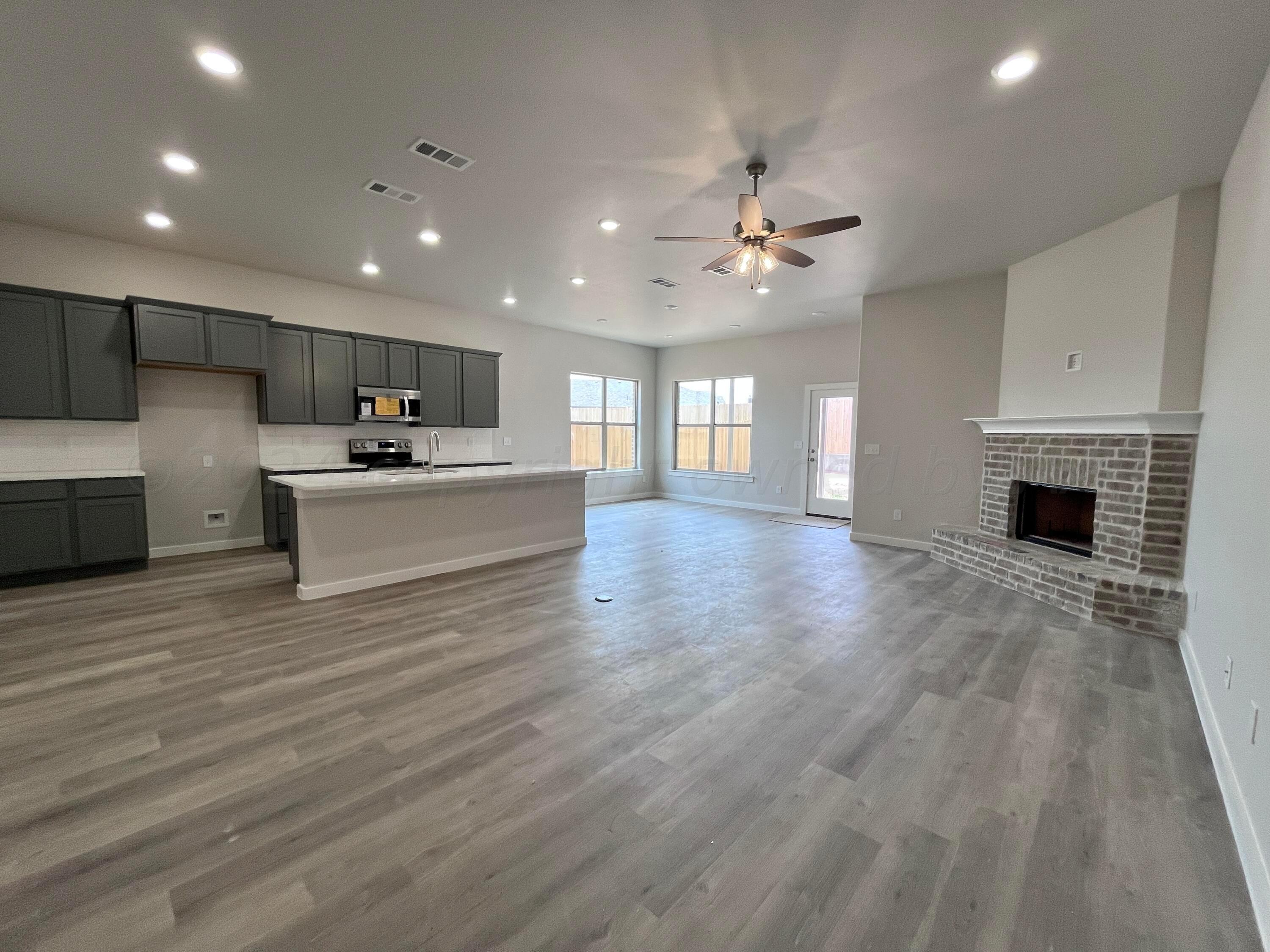 1605 Moon River Road Amarillo, TX 79118 - Photo 7 of 17 a large white kitchen with cabinets a sink and dishwasher