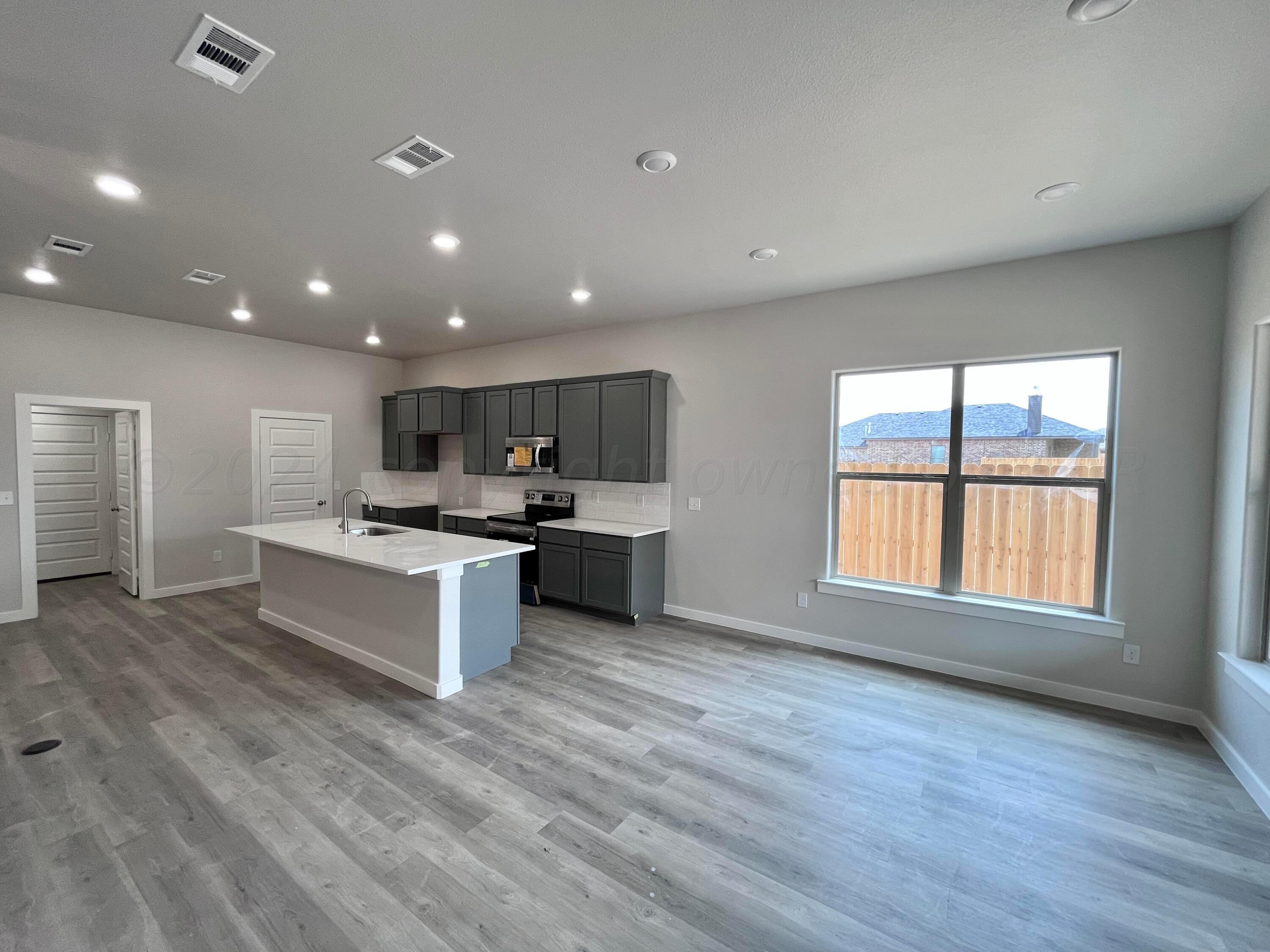 1605 Moon River Road Amarillo, TX 79118 - Photo 8 of 17 a large kitchen with a large counter top a sink stainless steel appliances and cabinets