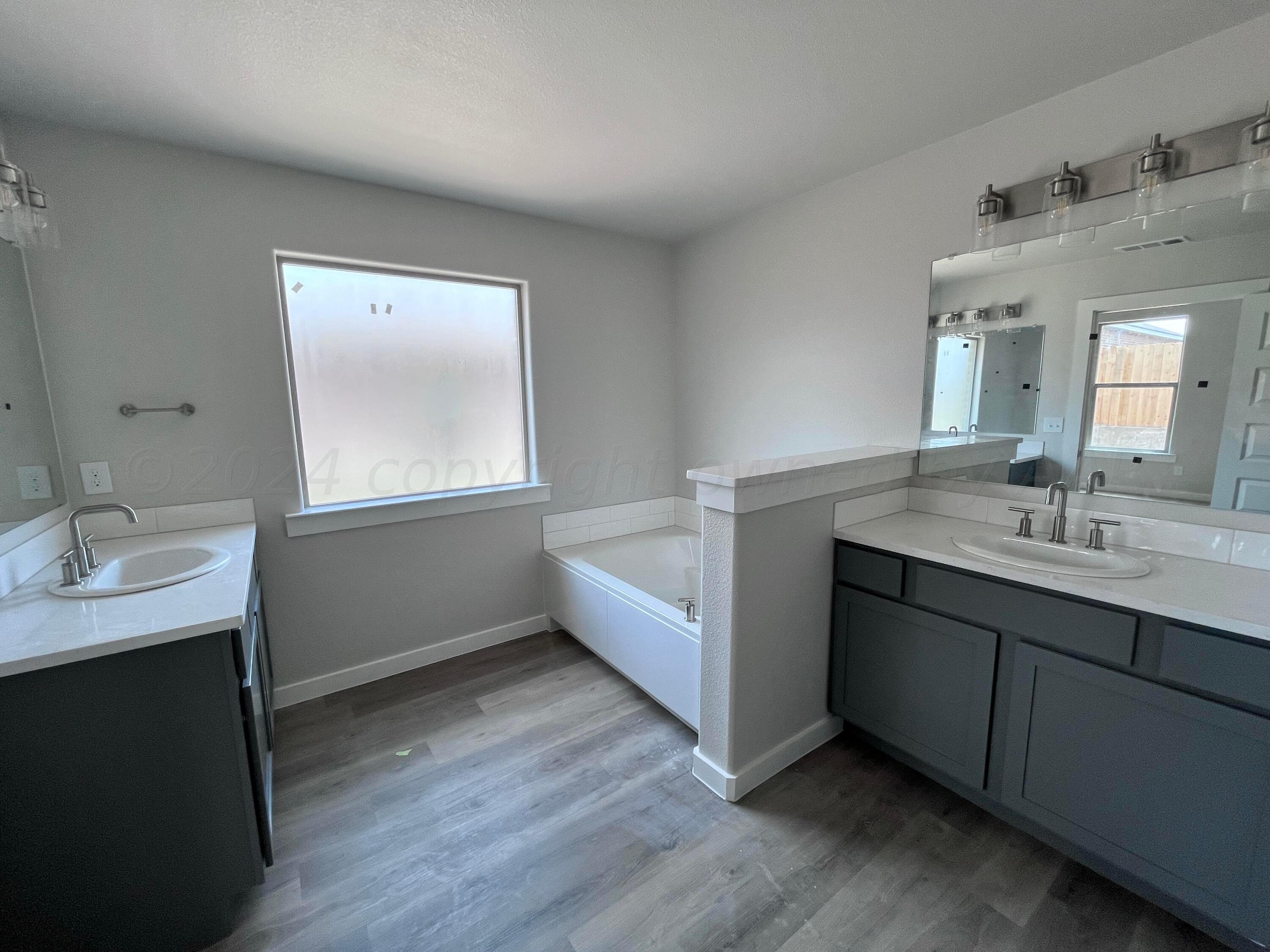 1605 Moon River Road Amarillo, TX 79118 - Photo 10 of 17 a bathroom with a double vanity sink mirror and