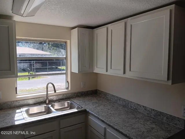 a bathroom with a sink and a window