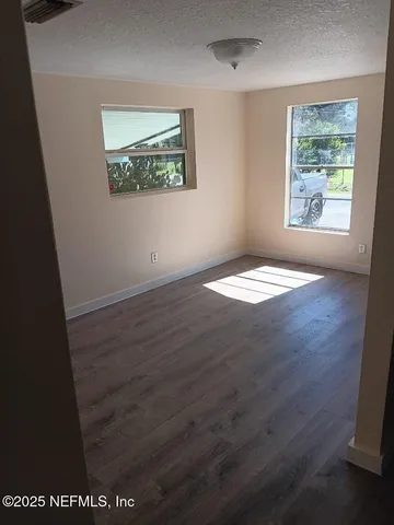 an empty room with wooden floor and closet