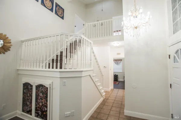 a view of staircase with white walls and windows