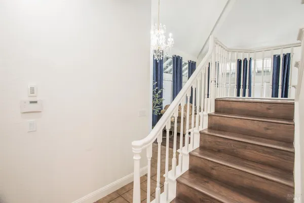 a living room with furniture ceiling fan and a large window