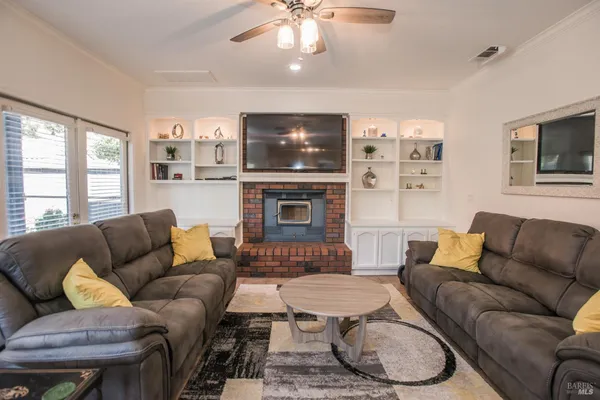 a living room with furniture kitchen and a chandelier