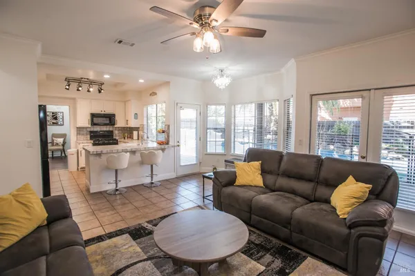 a kitchen with stainless steel appliances a stove a sink a microwave a refrigerator and cabinets