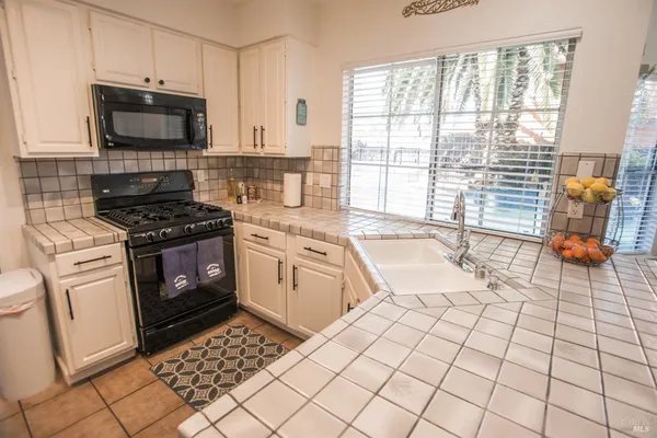 a view of a workspace with furniture and wooden floor