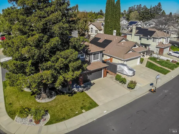an aerial view of a house with garden space and street view