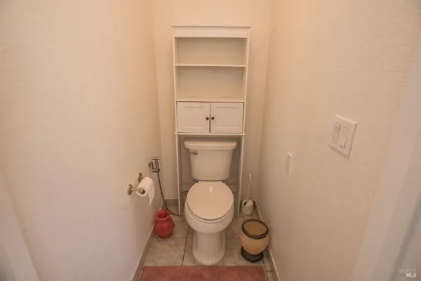 a view of a brick house with a iron fence