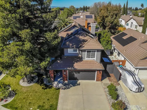 a view of a house with a yard and plant
