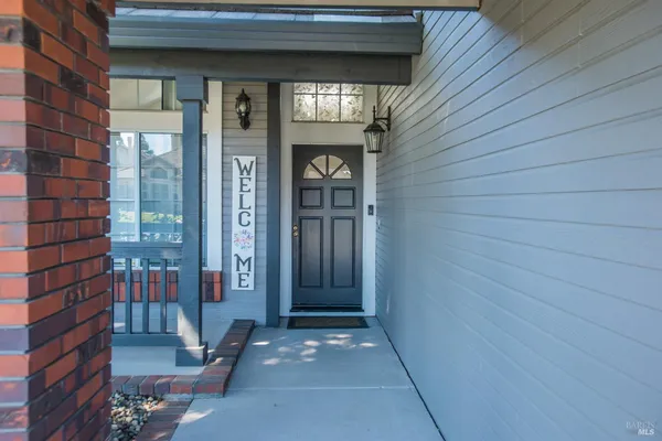 a living room with furniture a fireplace and a window