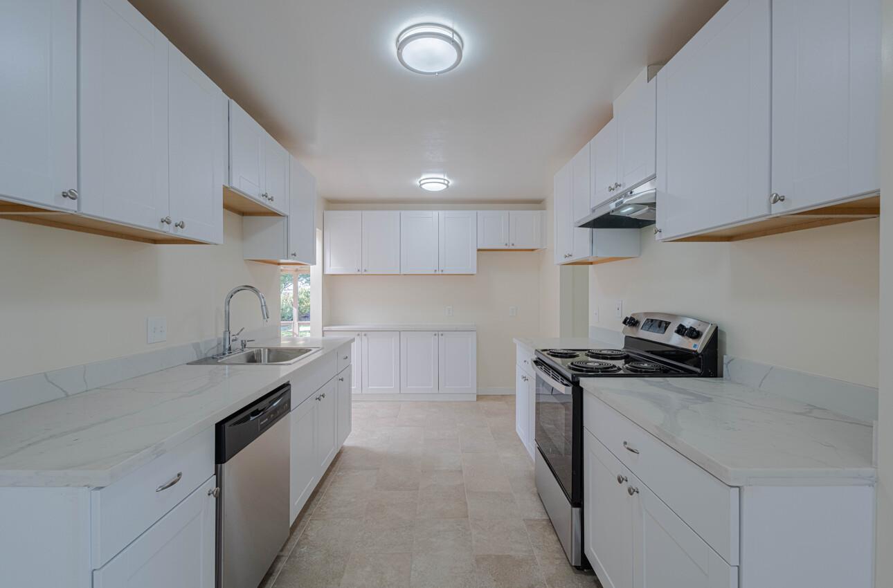 1221 Parkside Street Salinas, CA 93906 - Photo 11 of 41 a kitchen with granite countertop a sink stainless steel appliances and cabinets