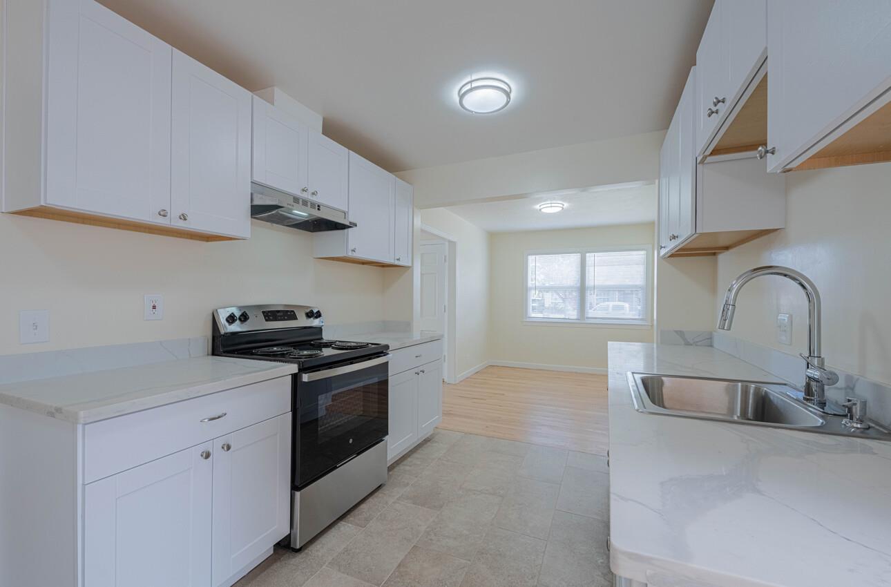 1221 Parkside Street Salinas, CA 93906 - Photo 13 of 41 a kitchen with stainless steel appliances granite countertop a sink a stove and a refrigerator