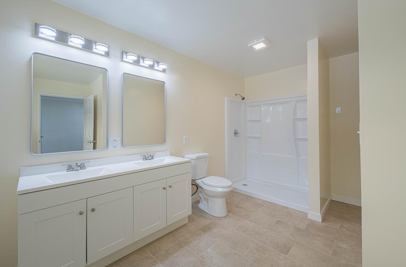1221 Parkside Street Salinas, CA 93906 - Photo 25 of 41 a bathroom with a double vanity sink toilet and shower