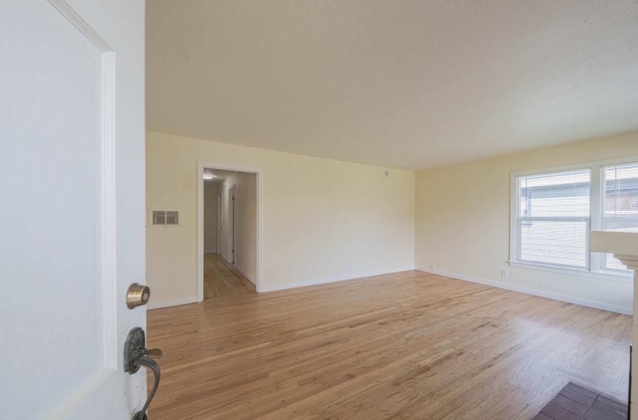 1221 Parkside Street Salinas, CA 93906 - Photo 5 of 41 a view of an empty room with wooden floor and a window