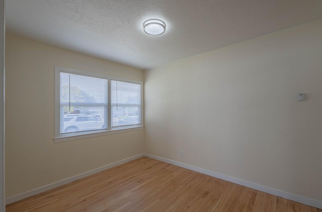 1221 Parkside Street Salinas, CA 93906 - Photo 9 of 41 an empty room with wooden floor and windows