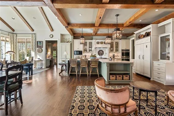 a view of staircase with railing and a chandelier