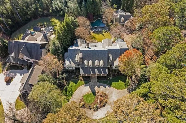 a living room with furniture a fireplace and a chandelier