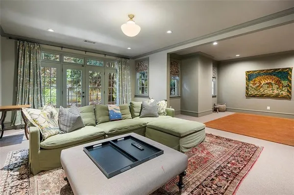 a bedroom with a bed and large windows