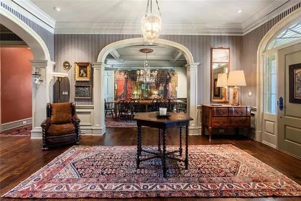 a living room with furniture a wooden floor and a large window
