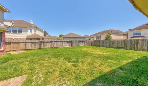 a view of a house with a yard and sitting area