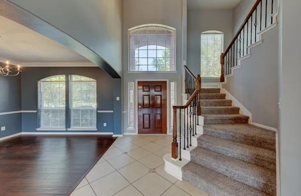 a view of entryway and hall with wooden floor