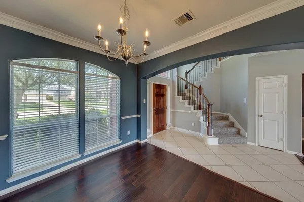 a view of a hallway with wooden floor and staircase