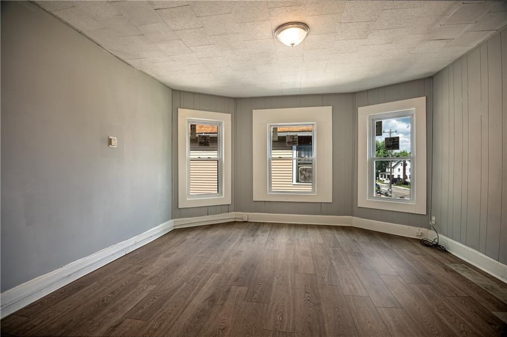 780 South Irvine Avenue, Unit 1 Sharon, PA 16146 - Photo 5 of 10 a view of an empty room with wooden floor and a window