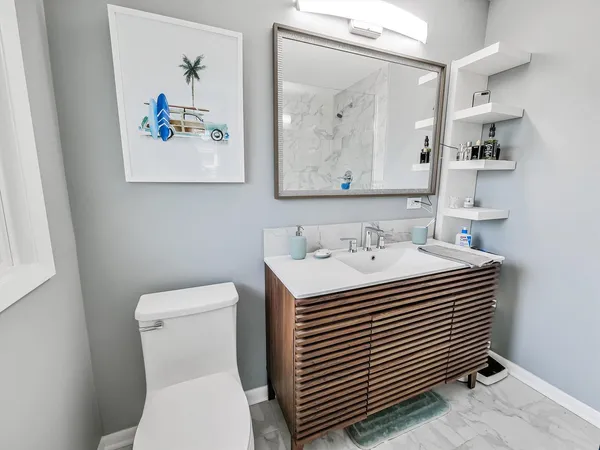 a bathroom with a sink a toilet and a mirror