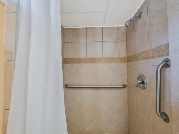a bathroom with a glass shower door