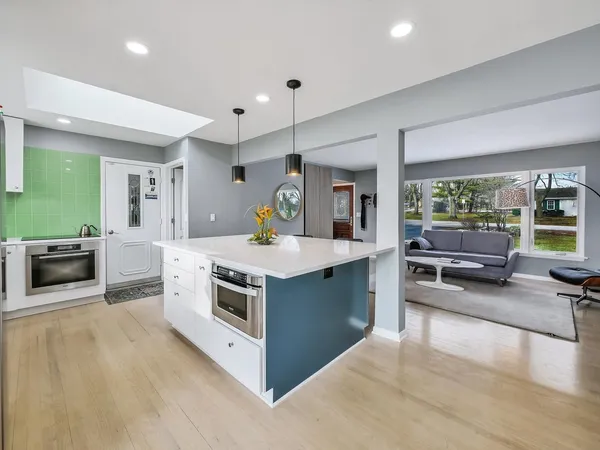 a kitchen with stainless steel appliances granite countertop a stove and a sink
