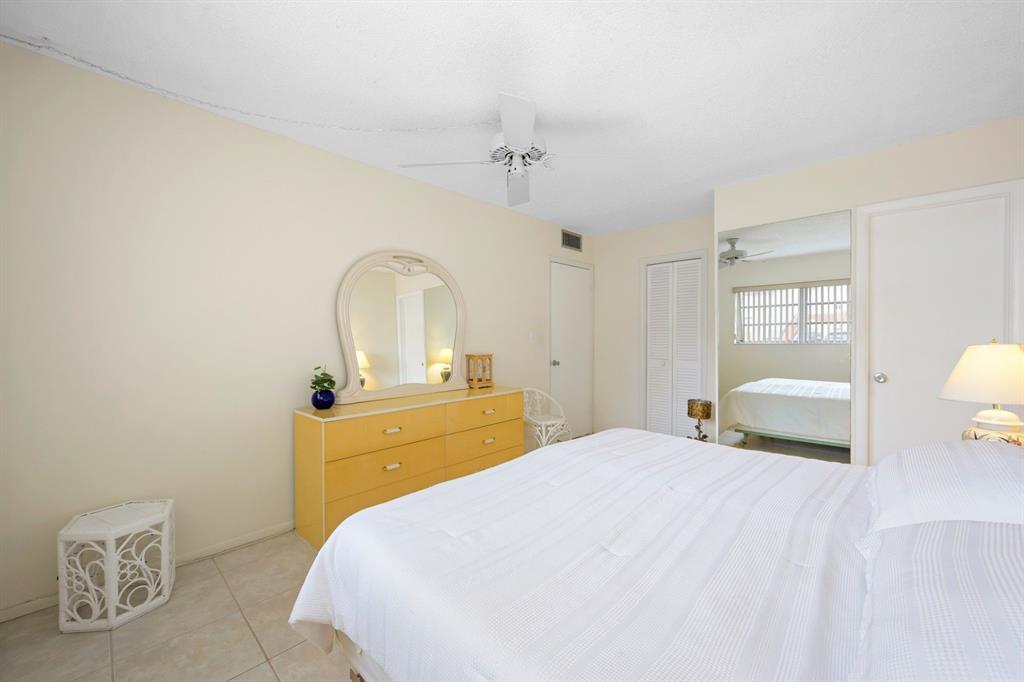 5300 Washington Street, Unit 108D Hollywood, FL 33021 - Photo 13 of 34 a bedroom with a bed and a mirror