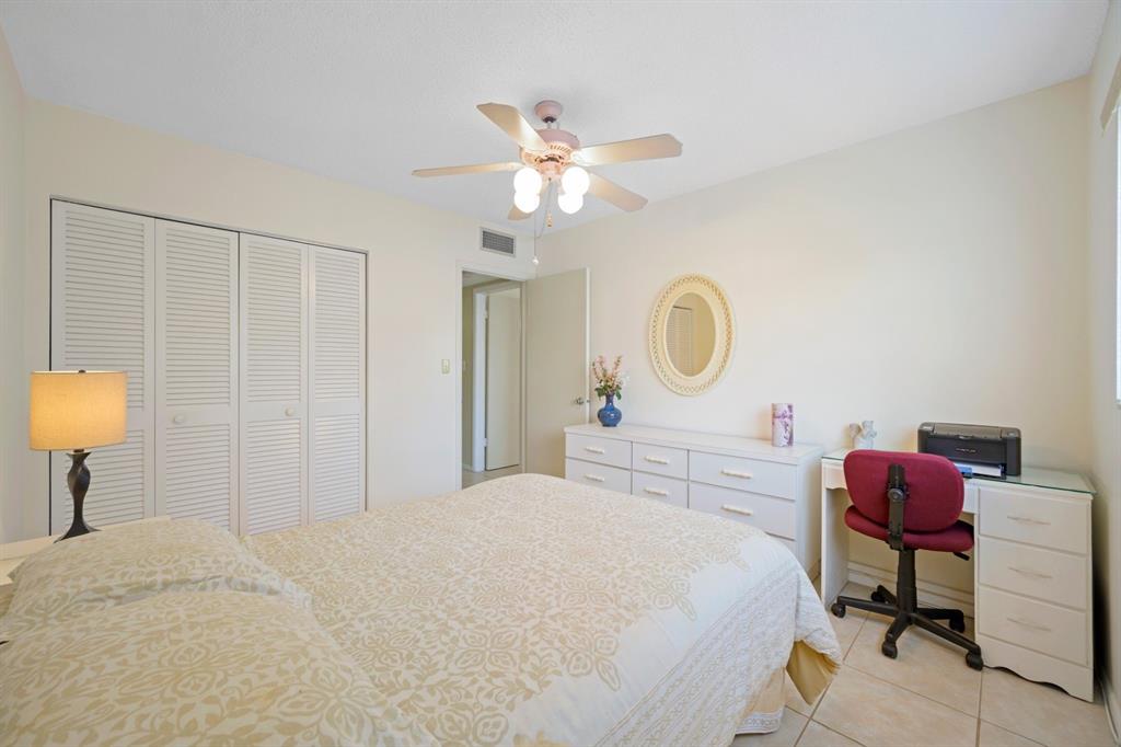 5300 Washington Street, Unit 108D Hollywood, FL 33021 - Photo 16 of 34 a bedroom with a bed and a chandelier