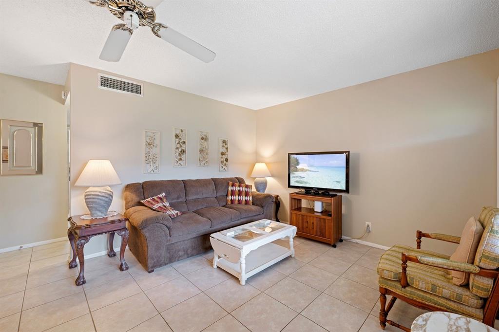 5300 Washington Street, Unit 108D Hollywood, FL 33021 - Photo 9 of 34 a living room with furniture and a flat screen tv
