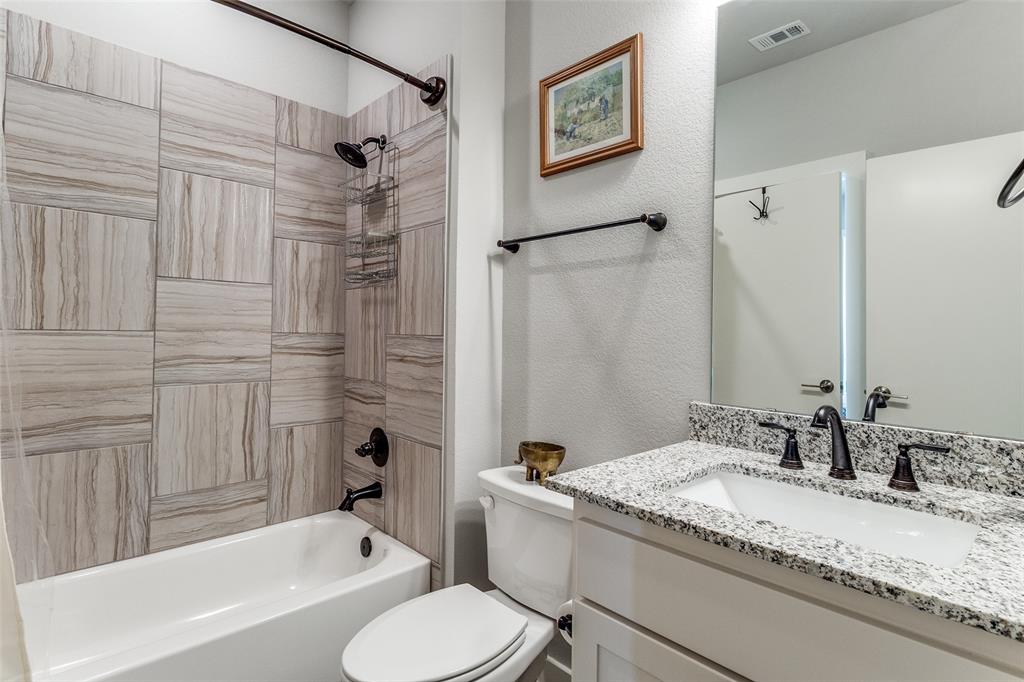 2220 Rook Drive Dallas, TX 75211 - Photo 12 of 13 a bathroom with a granite countertop sink toilet and shower