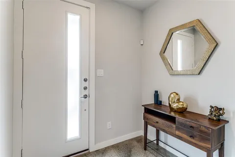 a living room with furniture and kitchen view